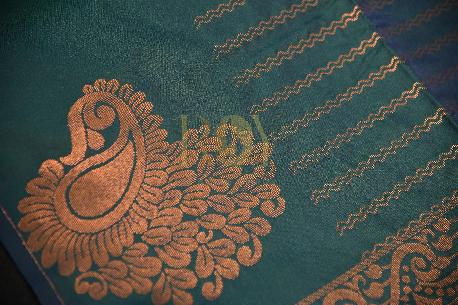 A soft silk saree woven  peacock green