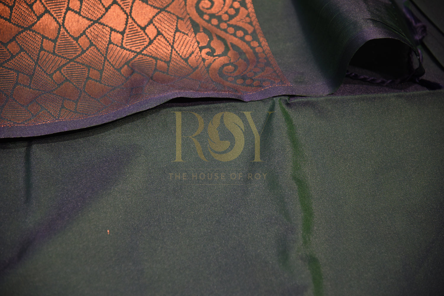 A soft silk saree woven  peacock green